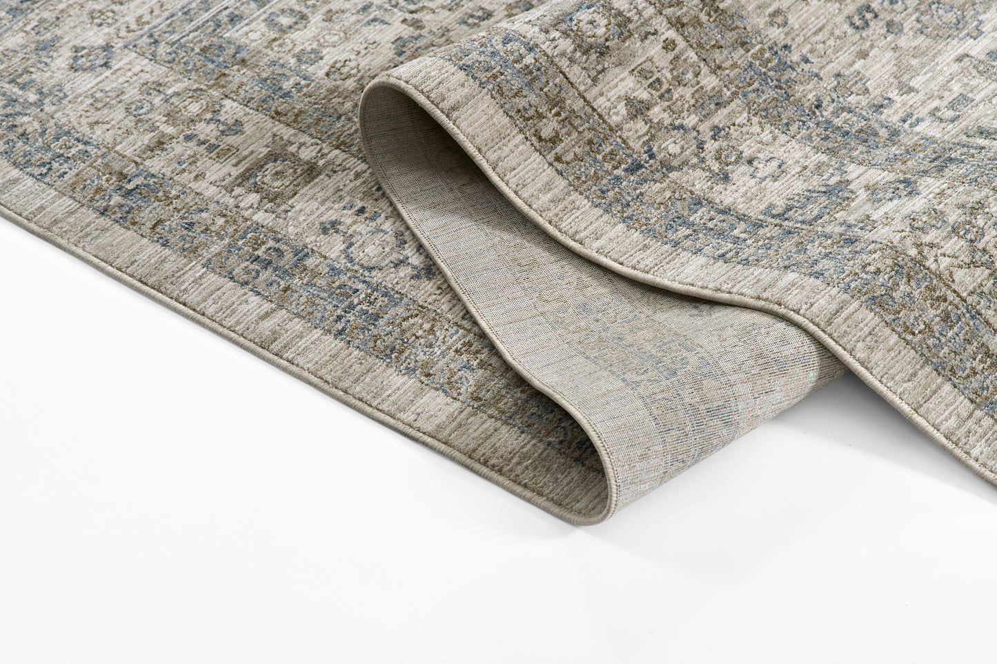 Blue-gray and beige distressed geometric rug with rolled edge, low-pile woven style.