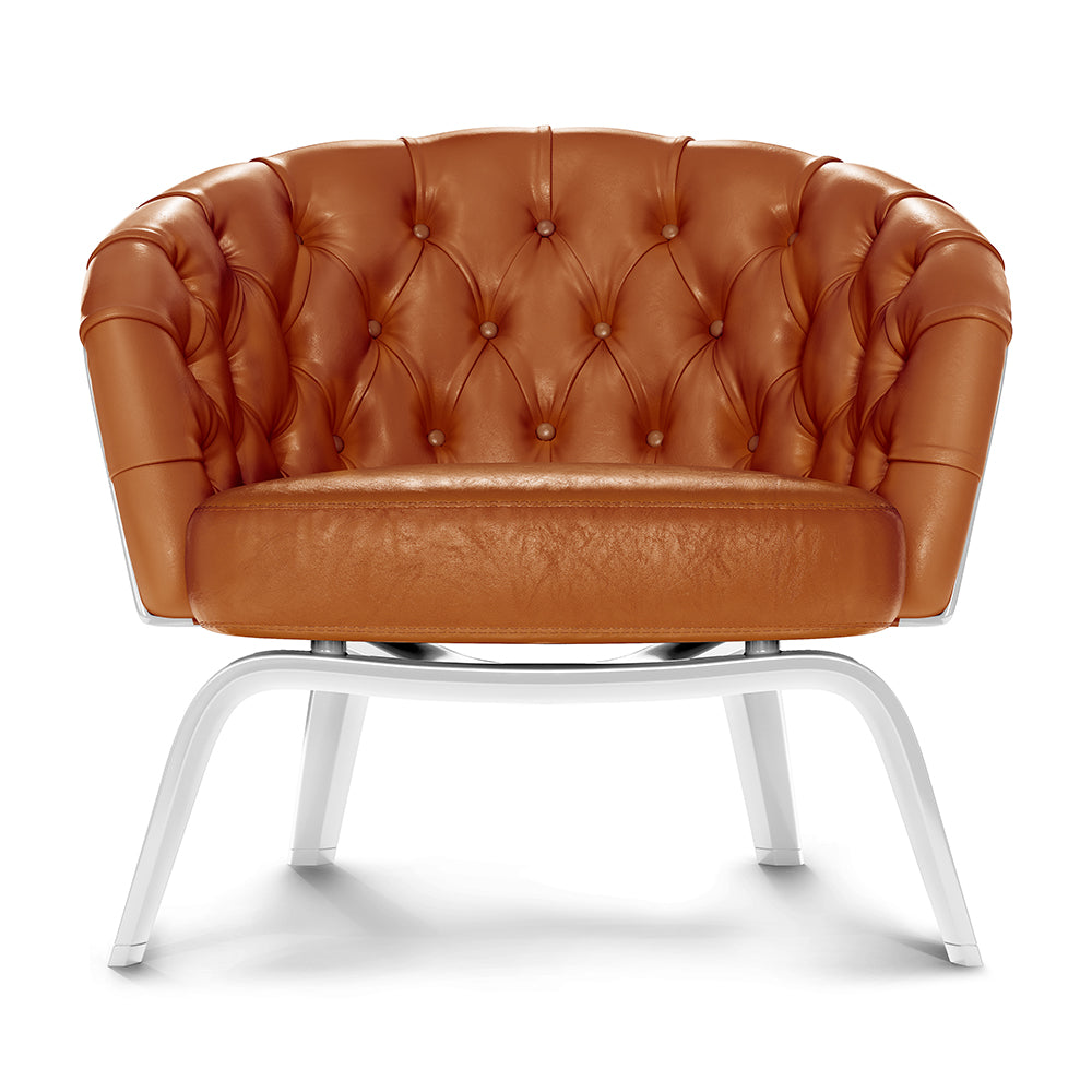 Burnt orange leather tufted lounge chair with button-tufted back, rounded arms, and white curved metal legs.