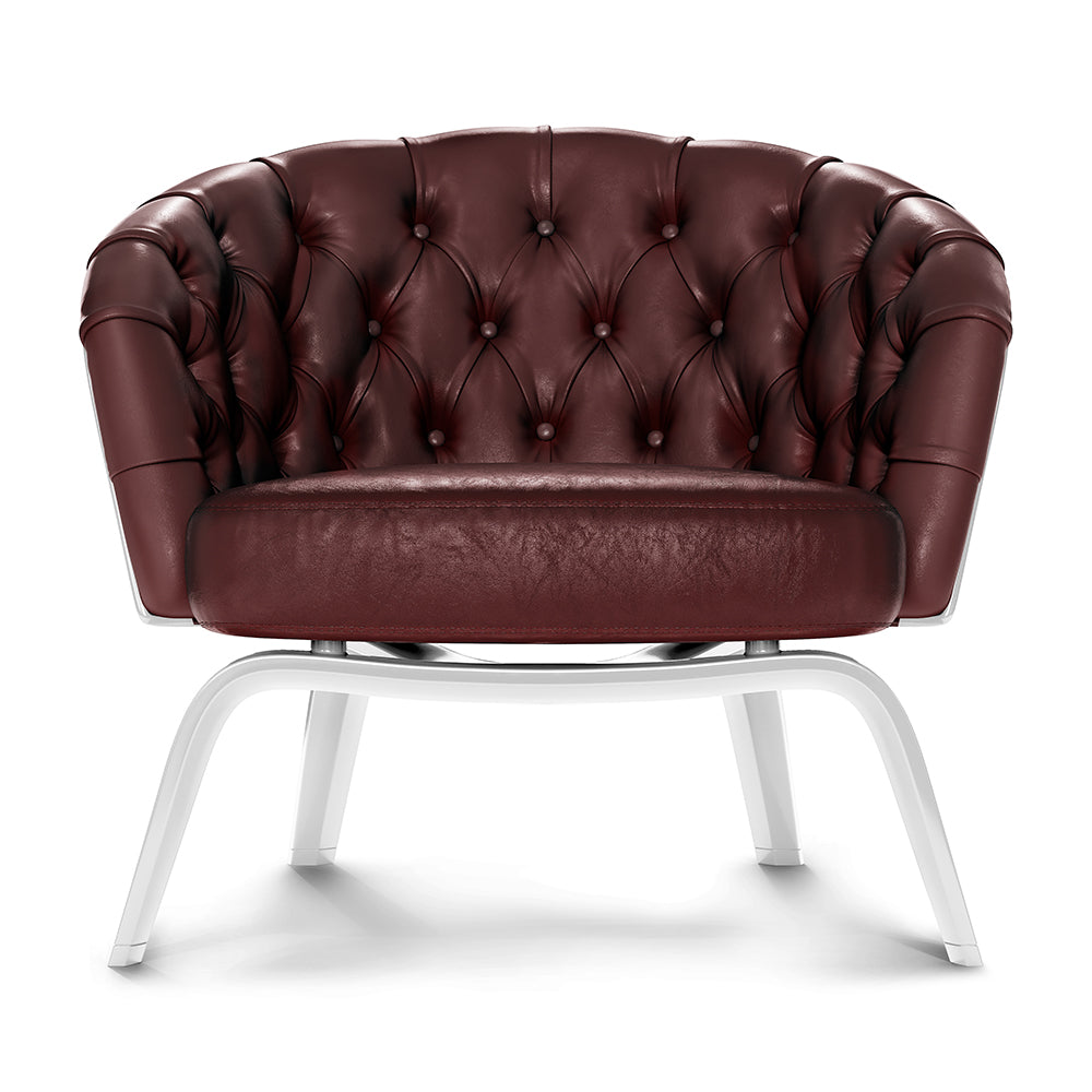 Burgundy tufted leather lounge chair with rounded arms and buttoned back, on white curved metal legs.