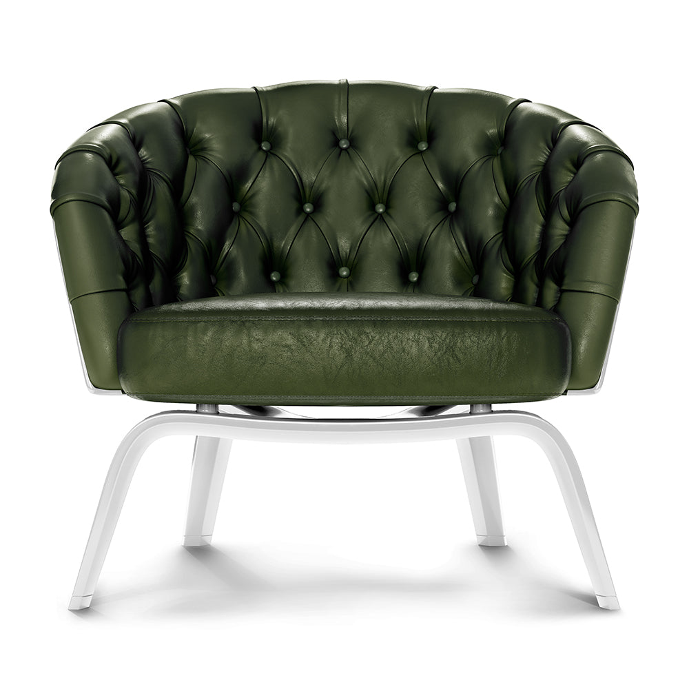 Dark green tufted leather lounge chair with buttoned back and white curved metal legs.