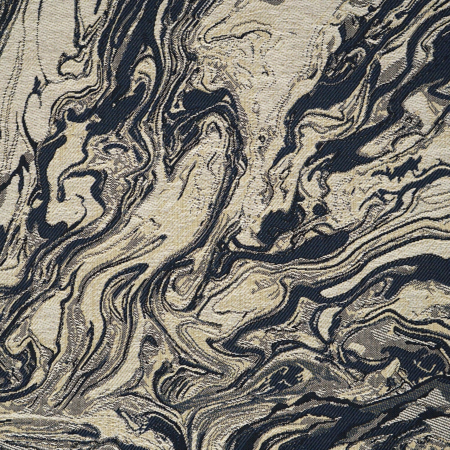 Beige and navy marbled fabric with flowing swirls; a chic textile for upholstery or drapery.