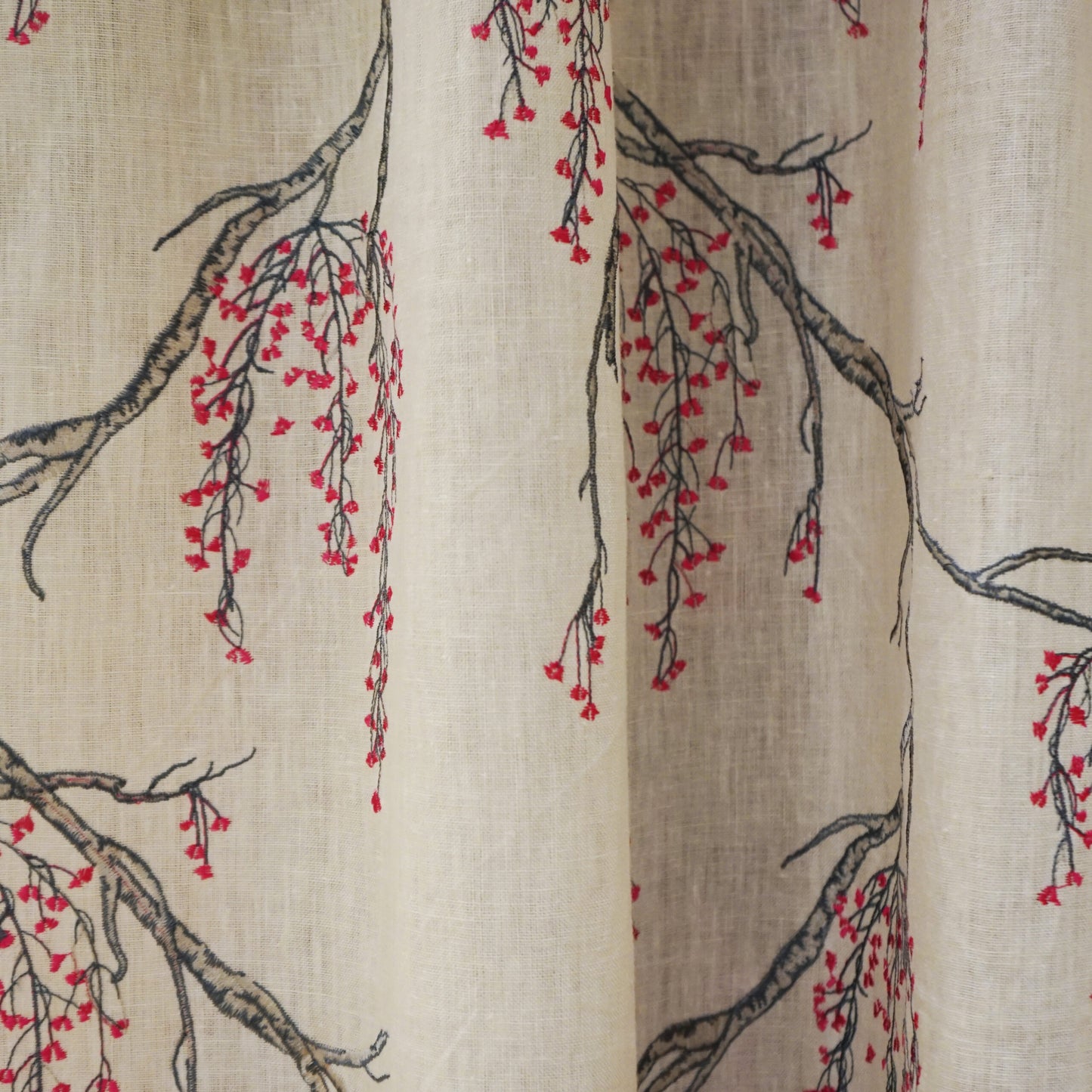 Beige linen fabric with dark tree branches & delicate pink blossoms, botanical print.