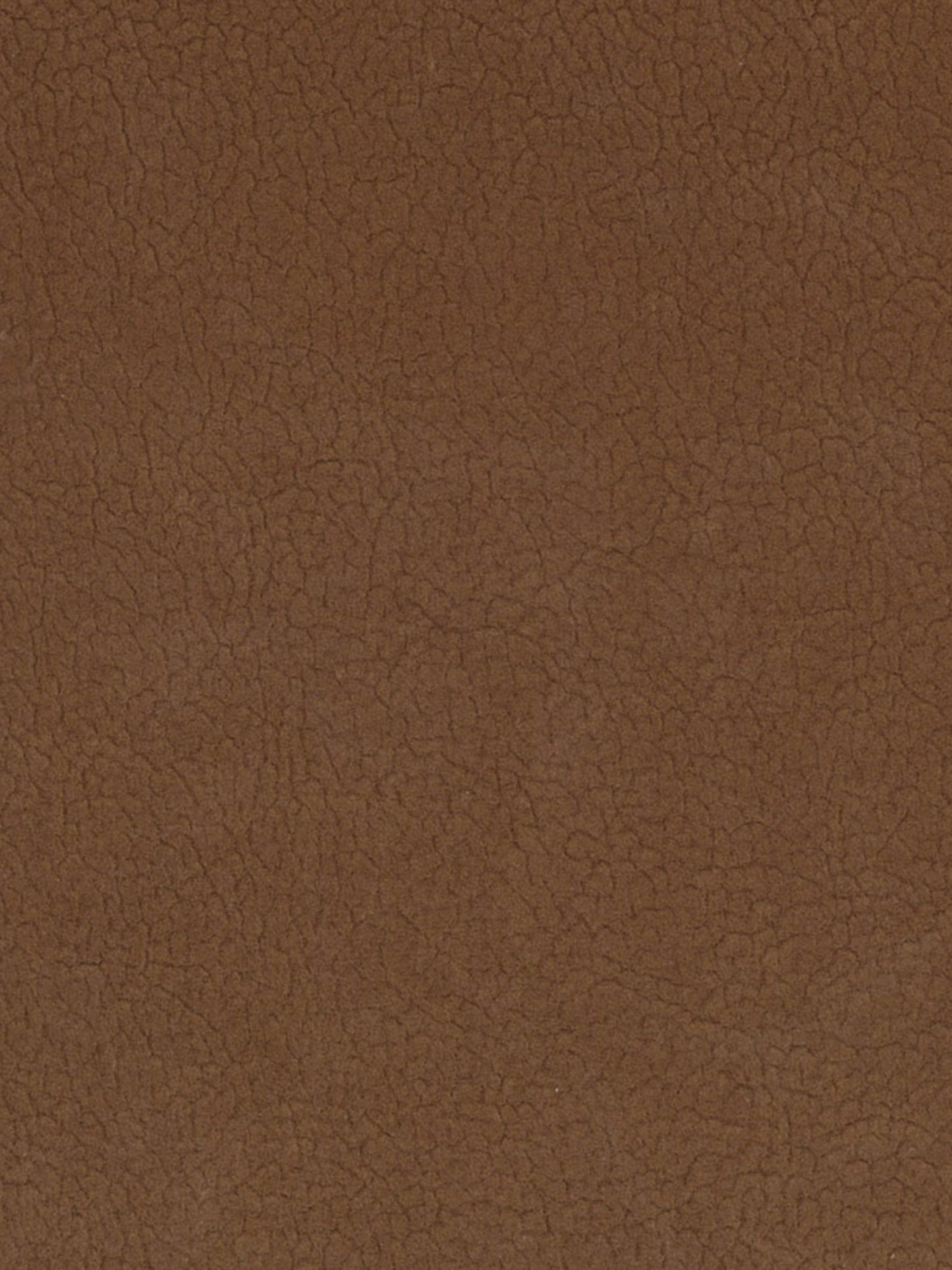 Close-up of brown leather texture with natural grain and warm tan color.