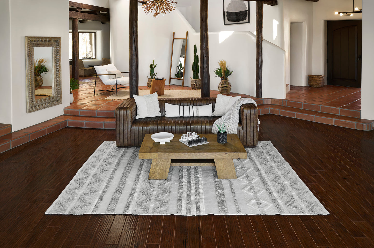 5' x 8' striped gray rug on the floor in a rustic living room.