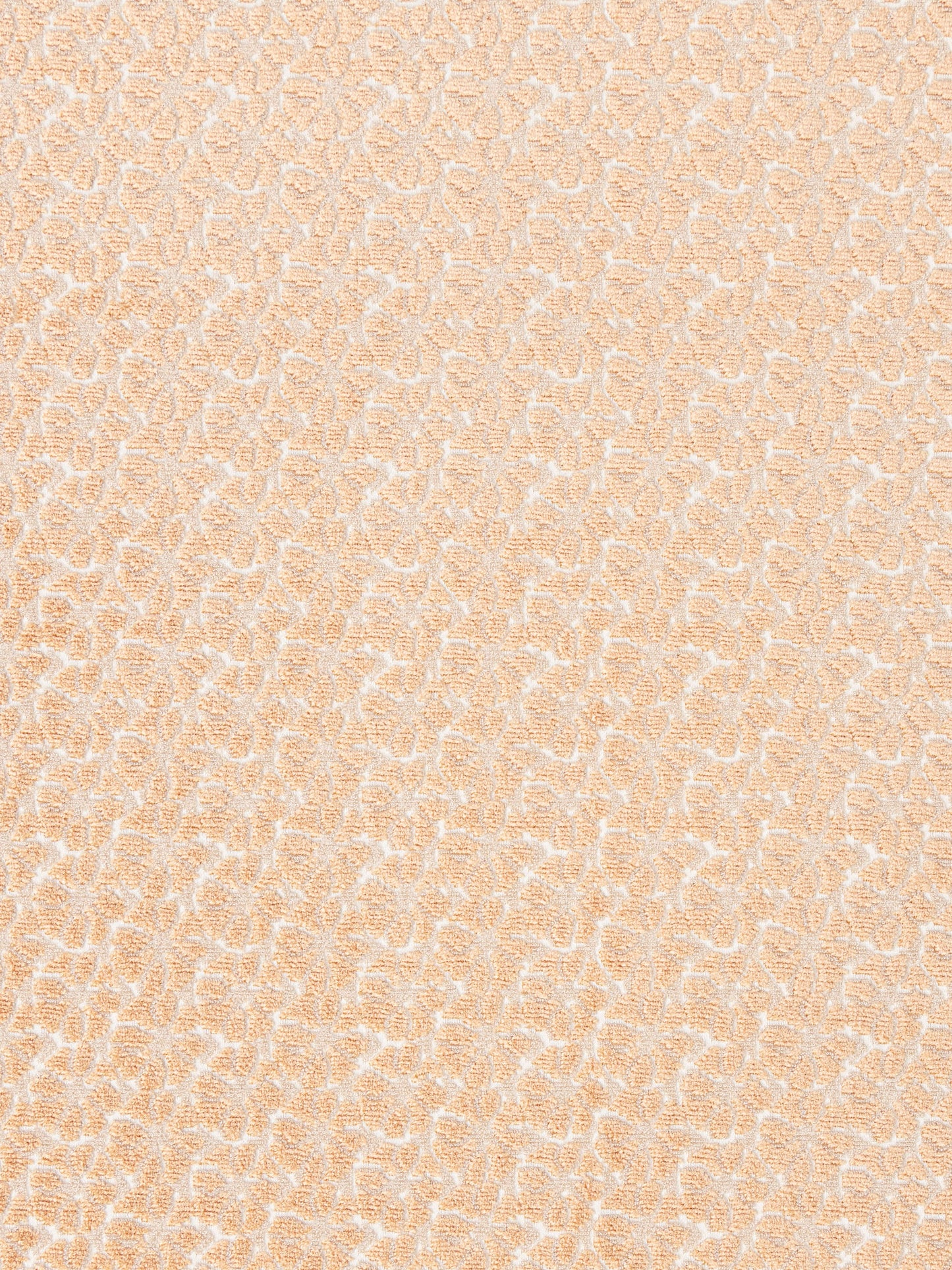 Peach jacquard fabric with delicate white damask motif; soft textured upholstery or drapery textile.