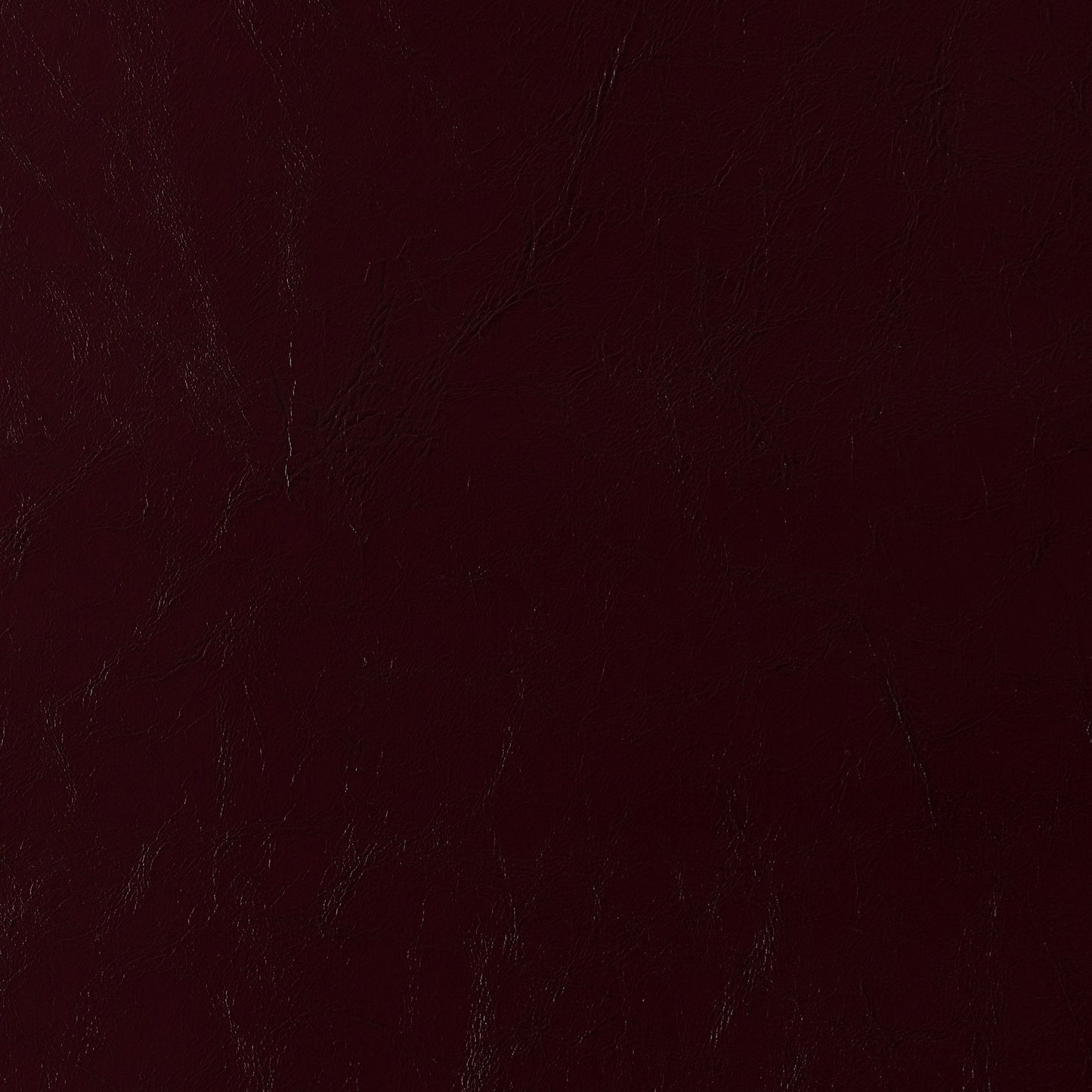 Dark burgundy faux leather texture with pronounced grain on vinyl fabric; rich maroon finish.