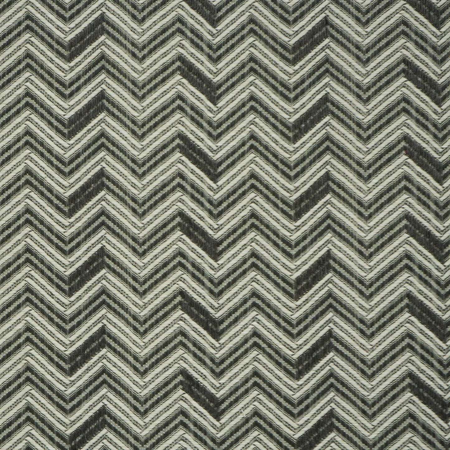 Gray and black chevron-patterned jacquard fabric with off-white accents; bold zigzag woven design.