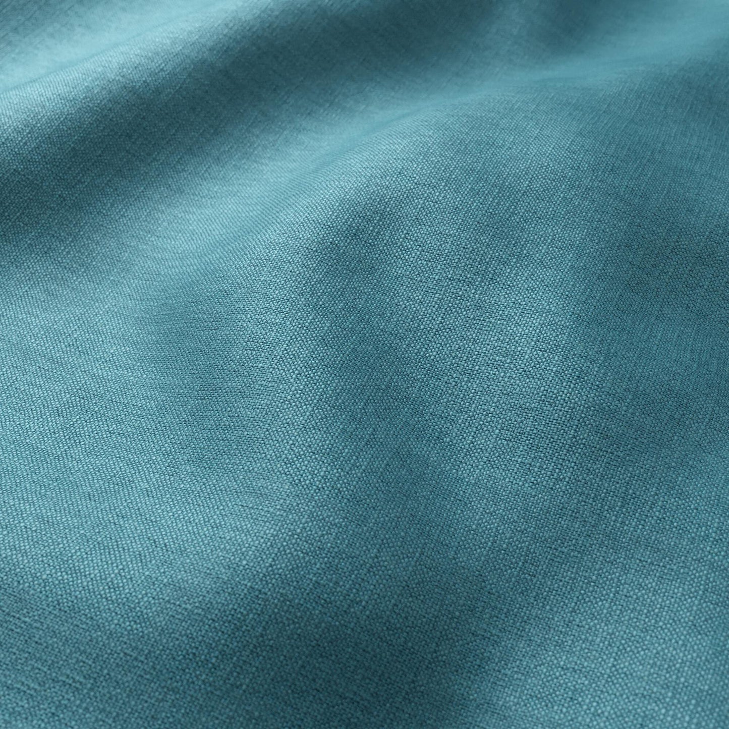 Teal blue linen-like fabric close-up with soft drape and textured weave.