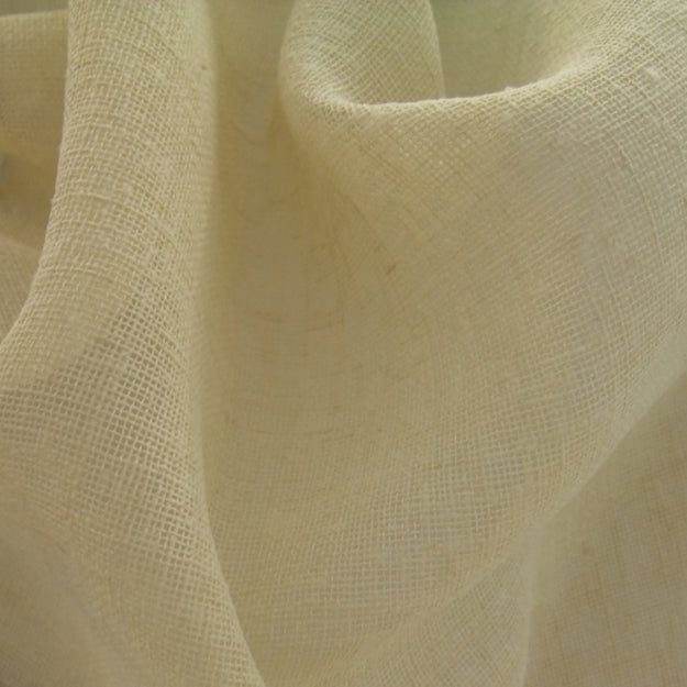 Cream linen fabric close-up with visible textured weave and soft drape.