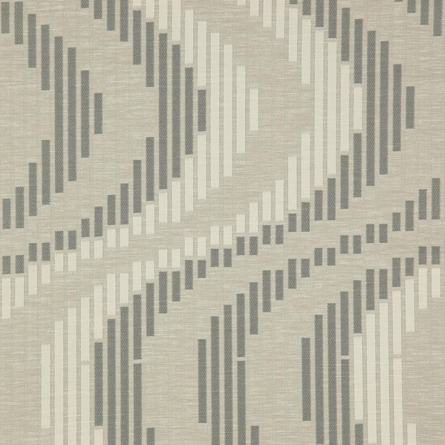 Beige woven fabric with overlapping diagonal chevron stripes in dark and light gray; textured geometric pattern.