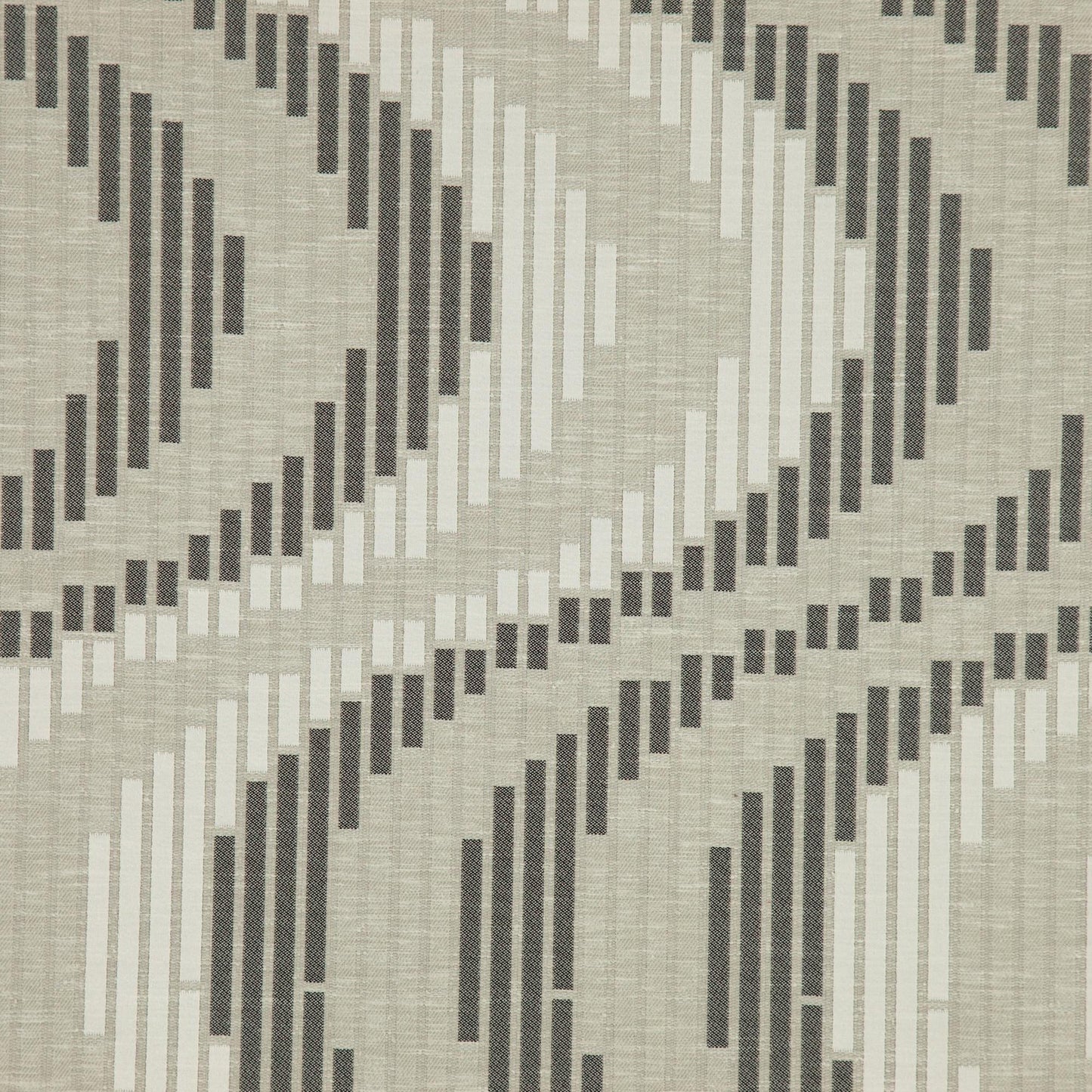 Black jacquard fabric with geometric scroll pattern and textured weave.