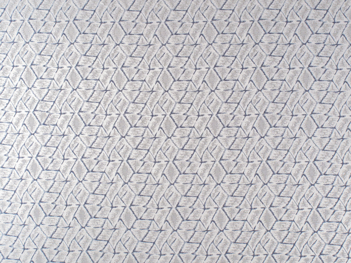 Blue textured fabric with an interlocking navy diamond lattice pattern, modern upholstery.