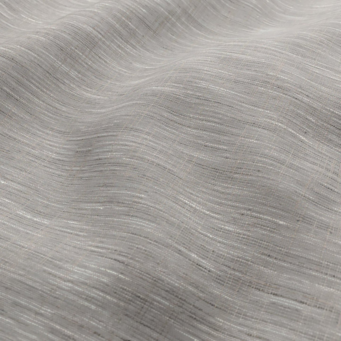 Light grey fabric with a subtle woven texture and soft drape; wide width, sheer fabric in grey, cream and beige.