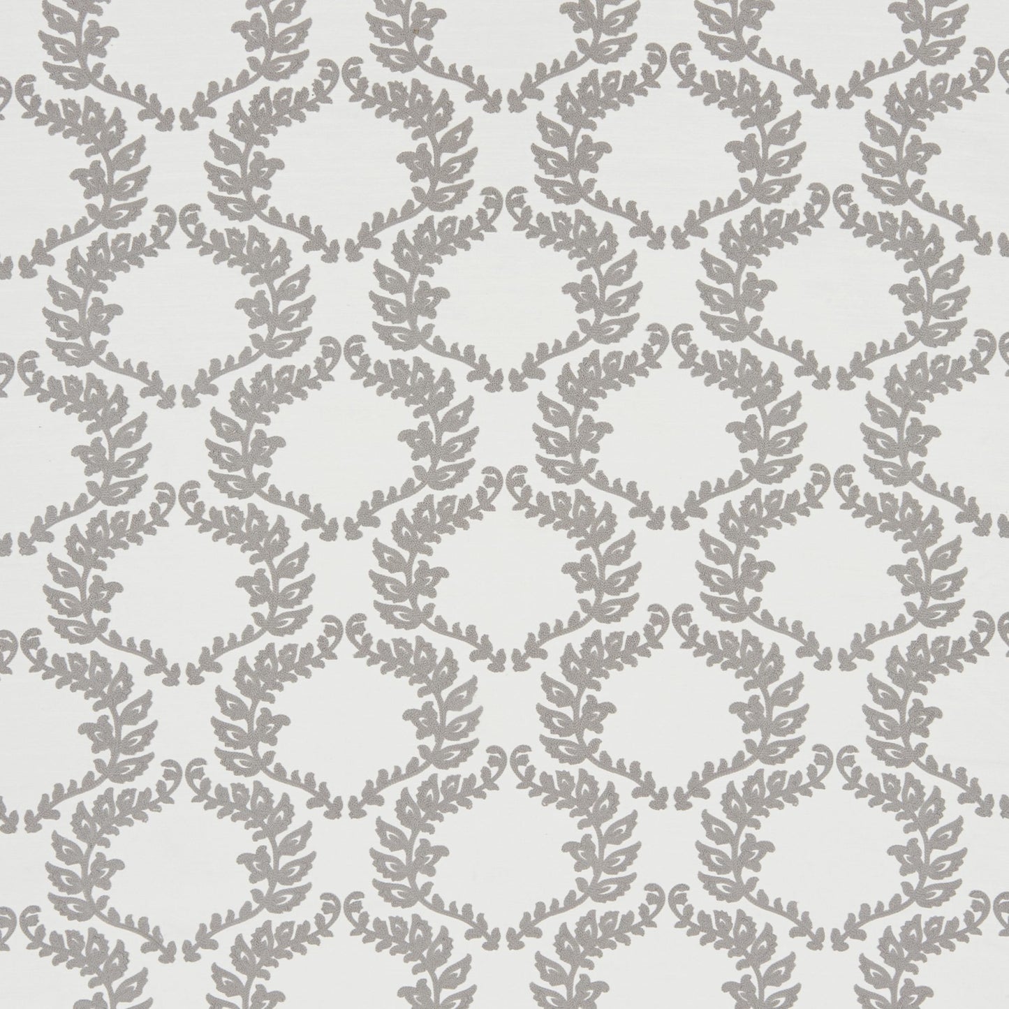 Grey leafy vine trellis pattern on pale background; embroidered floral fabric.