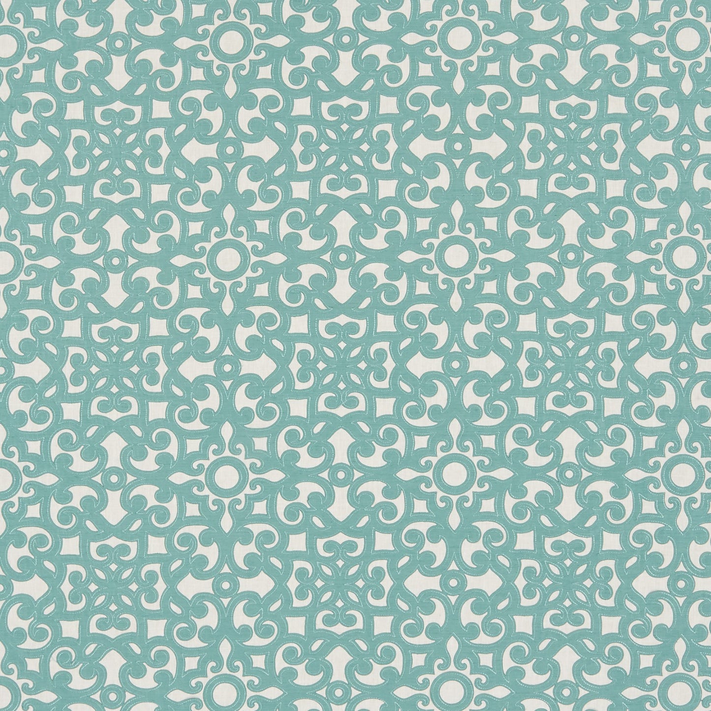 Blue floral scroll embroidery on light cream fabric.