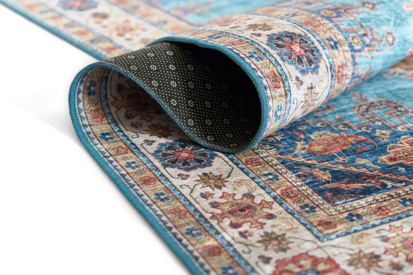 Turquoise oriental rug with cream border and floral medallions, rolled to show underside; Persian-inspired pattern.
