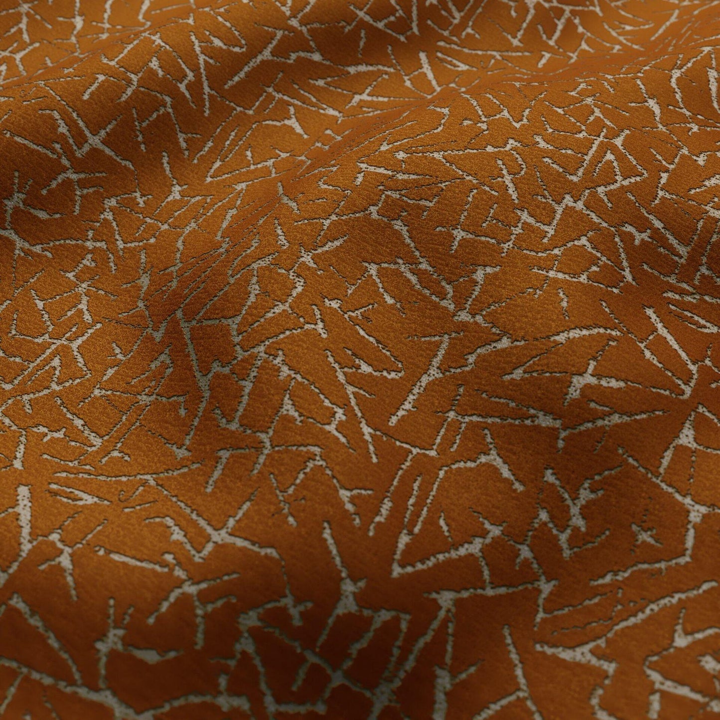 Abstract mustard and silver velvet fabric with a textured surface.