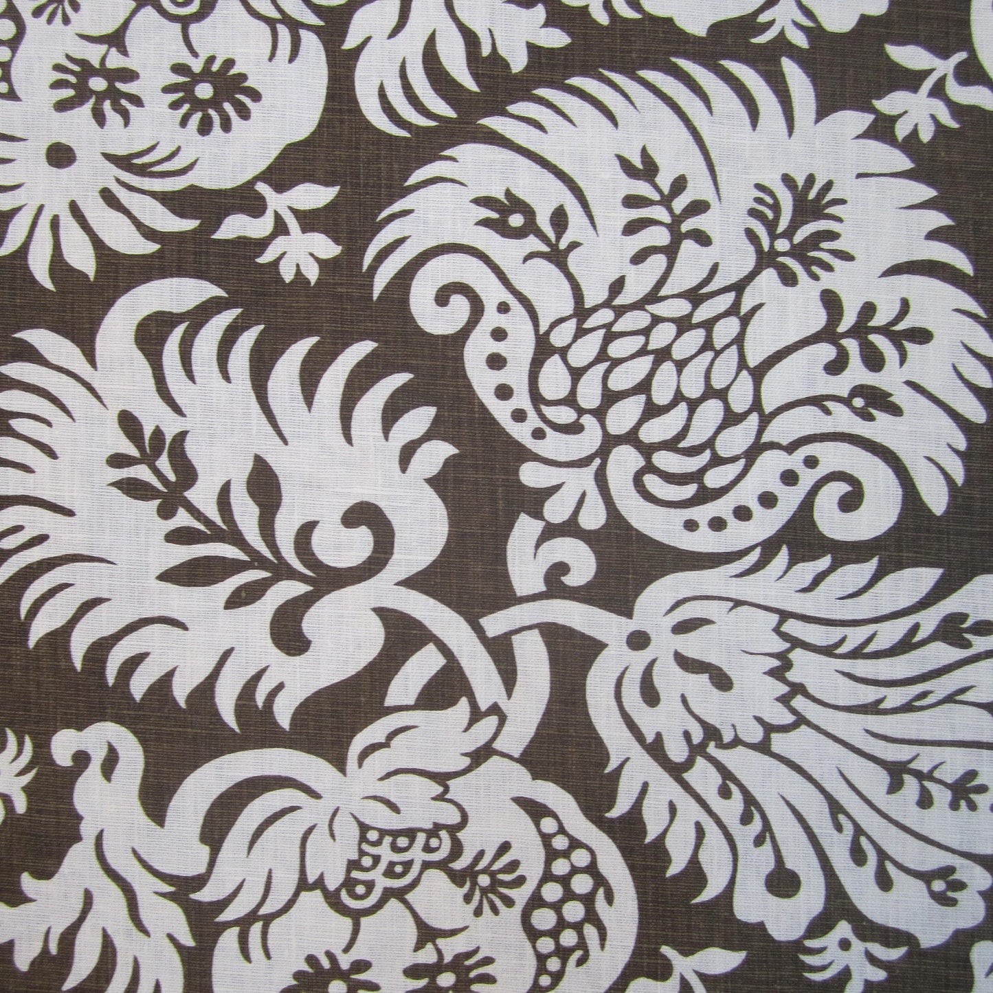 Brown damask-patterned linen fabric with white ornate floral scrolls; classic upholstery or drapery textile.