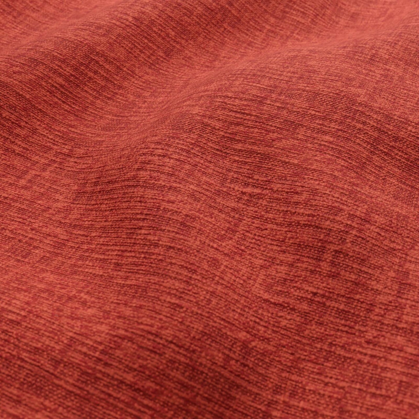 Close-up of rust-red plain woven fabric with soft texture and subtle linear weave.