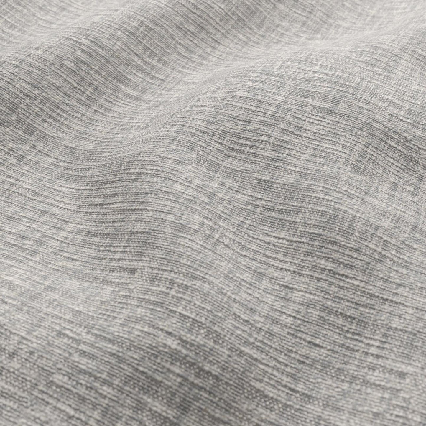 Close-up of heather gray woven fabric with soft, wavy texture and folds.