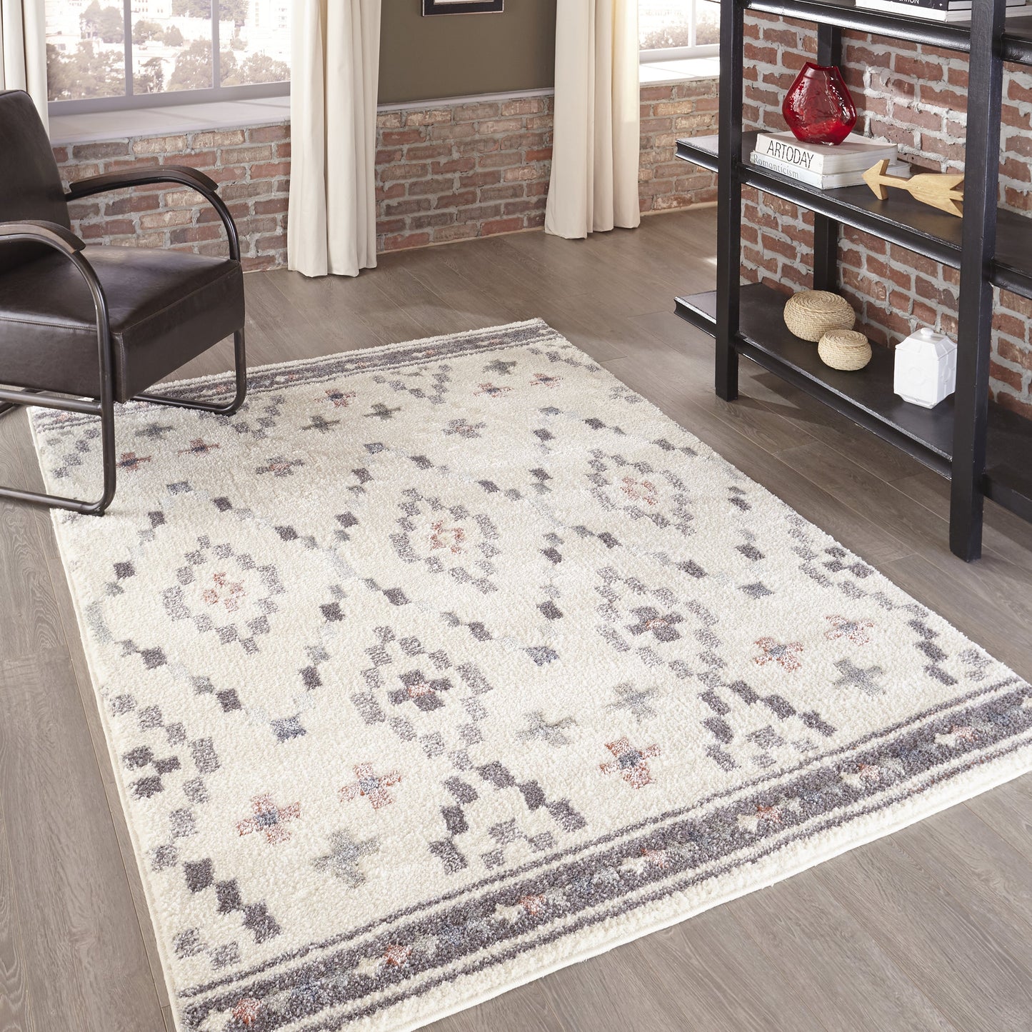 Ivory woven area rug with subtle gray and blush floral medallion pattern and border, ideal for a living room.