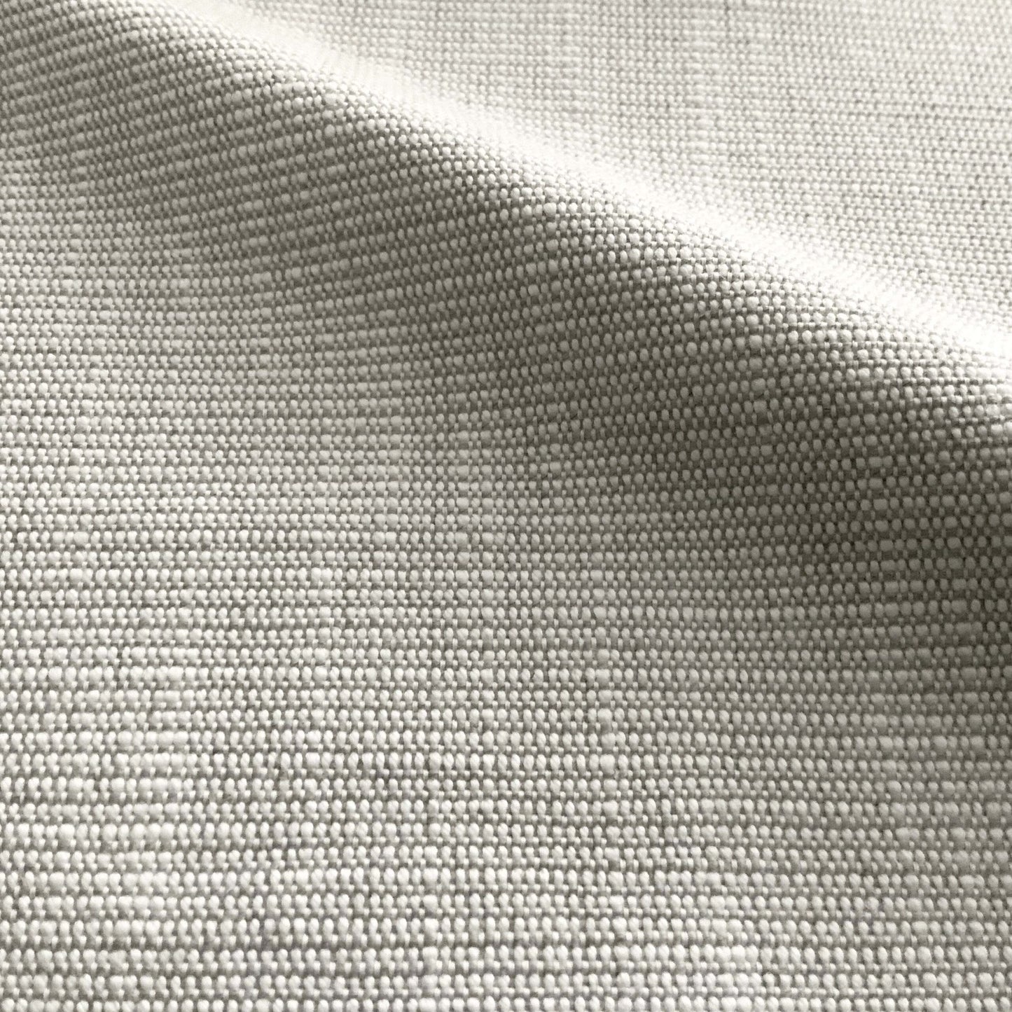 Close-up of light gray woven fabric with a subtle grid texture and soft drape.