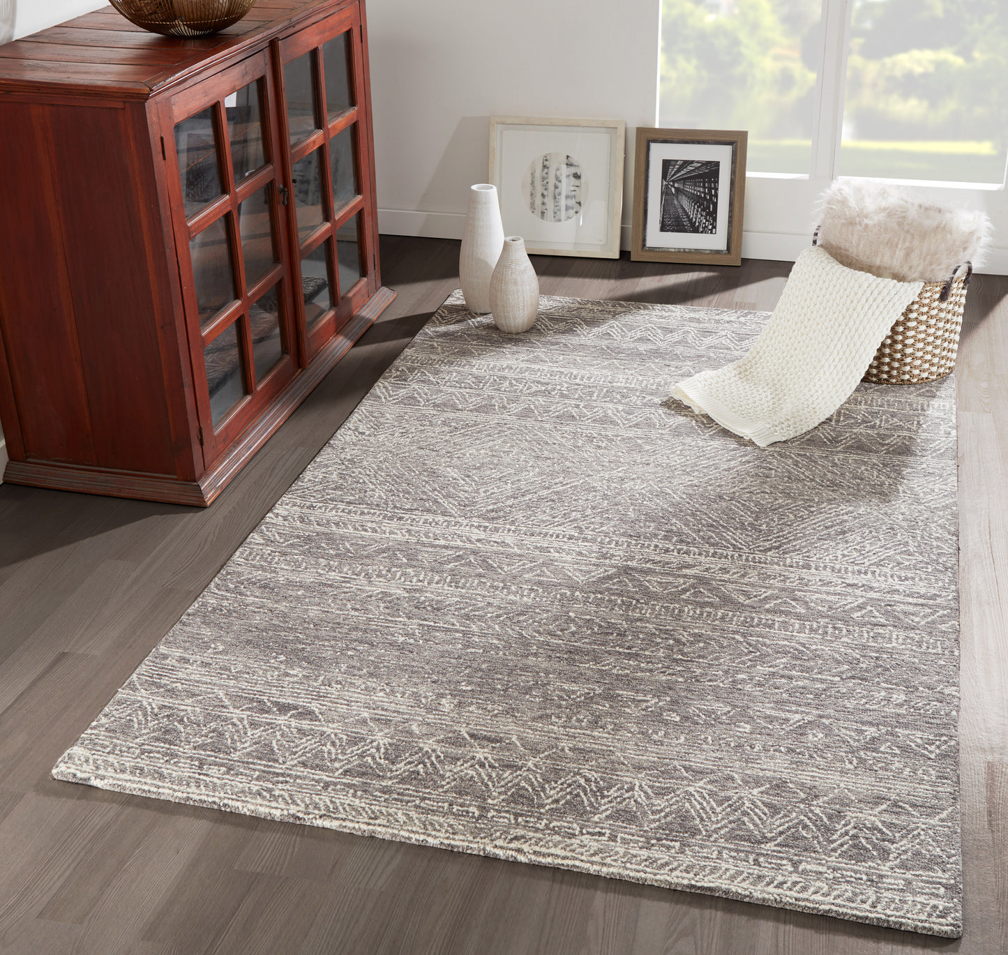 Rectangular gray rug with white geometric patterns; modern textured look for living room decor.