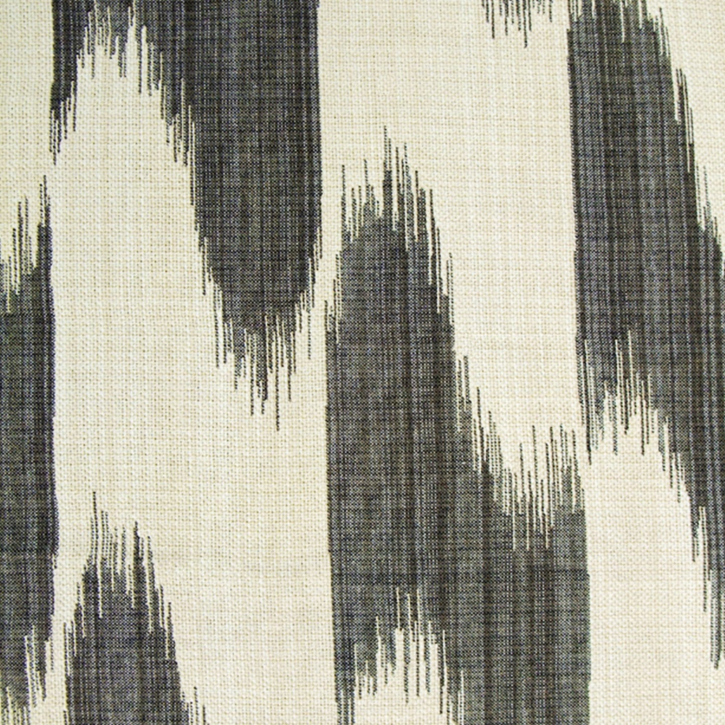 Beige fabric with abstract charcoal gray zigzag brushstroke pattern; ikat-inspired textile for upholstery or rug.
