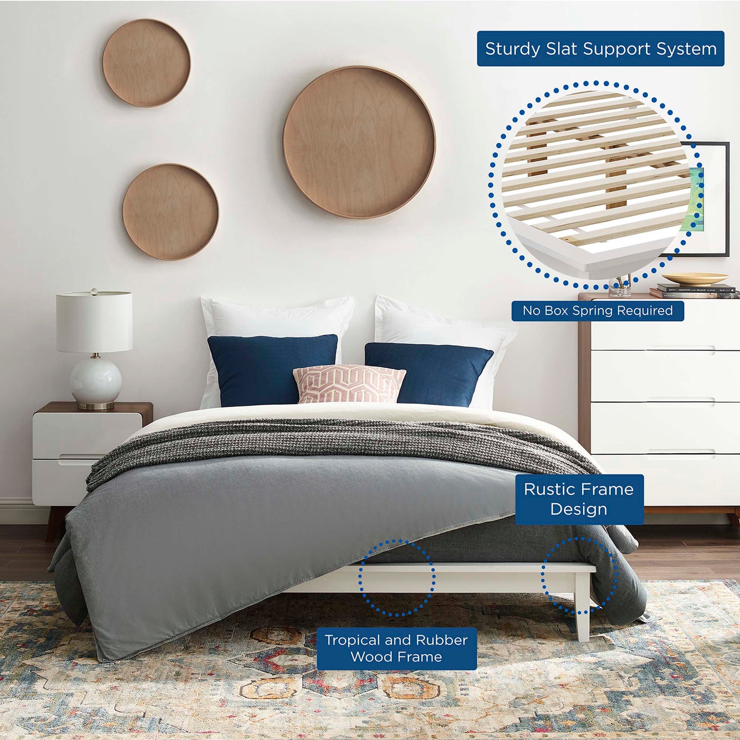 Low-profile white platform bed with rustic rubber wood frame and slat support; gray bedding with navy pillows.
