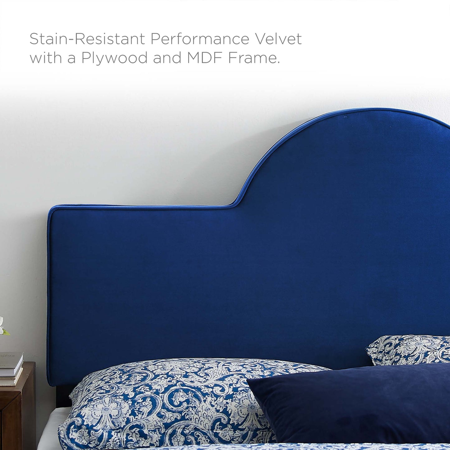 Stain-resistant navy velvet headboard with a scalloped curved top, MDF/plywood frame, paired with blue damask bedding.
