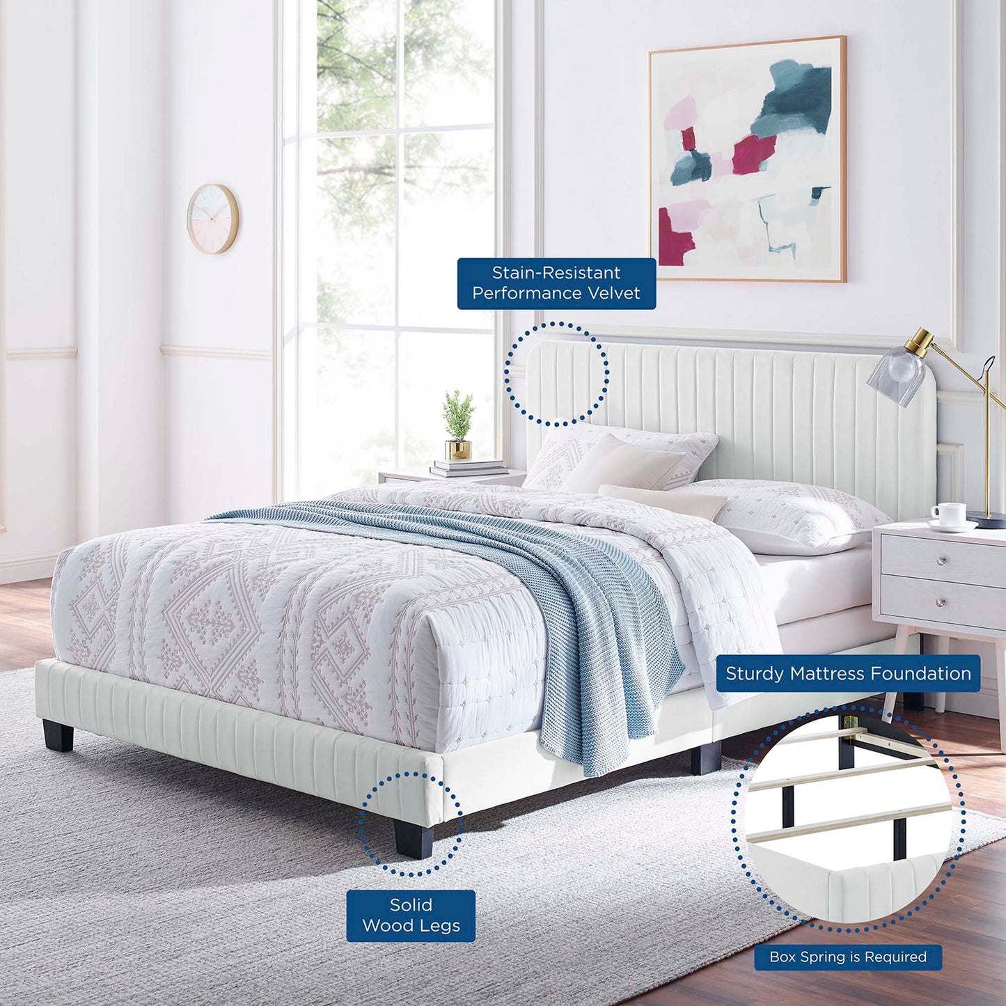 White tufted upholstered platform bed with stain-resistant velvet, solid wood legs, in a modern bedroom.