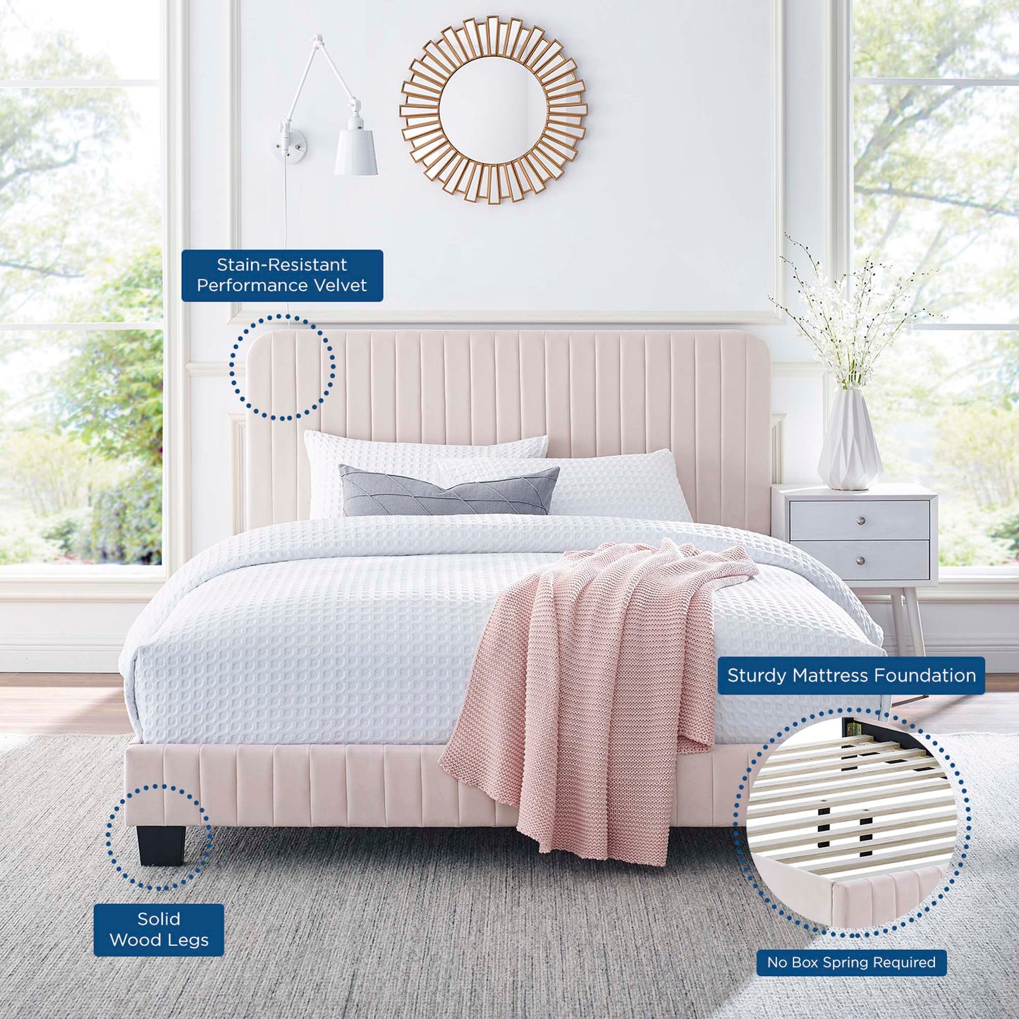 Red velvet upholstered bed with vertical channel tufting, white bedding, red throw, round sunburst mirror, solid wood legs