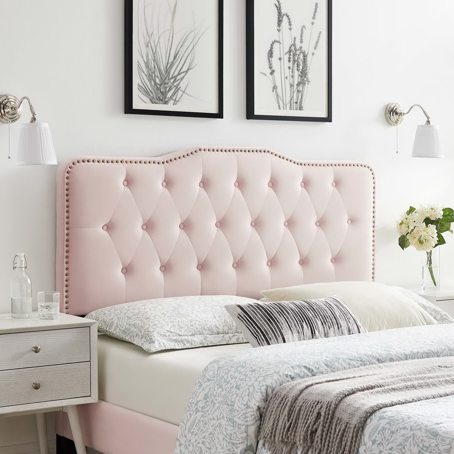 Red tufted velvet twin headboard with nailhead trim, white bedding, matching nightstands & botanical wall art.