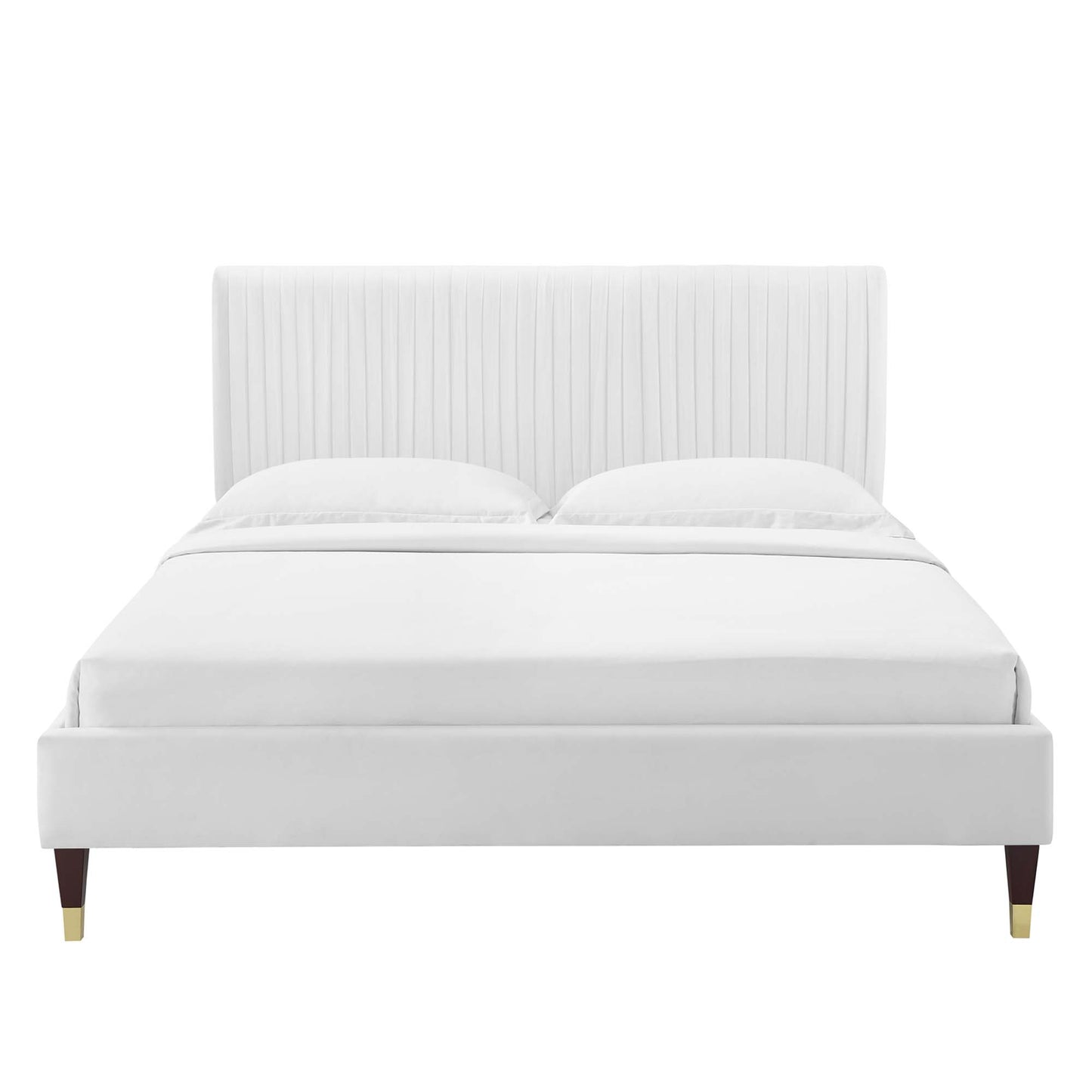 White upholstered platform bed with tall vertical-channel headboard, clean lines, and wood legs with brass caps.