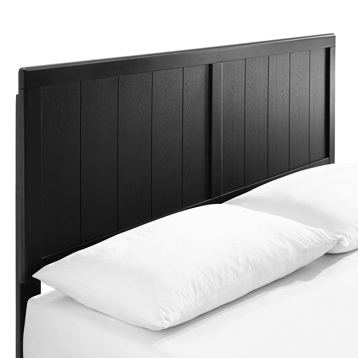 Black wooden panel headboard with vertical slats on a bed, paired with white pillows and bedding.