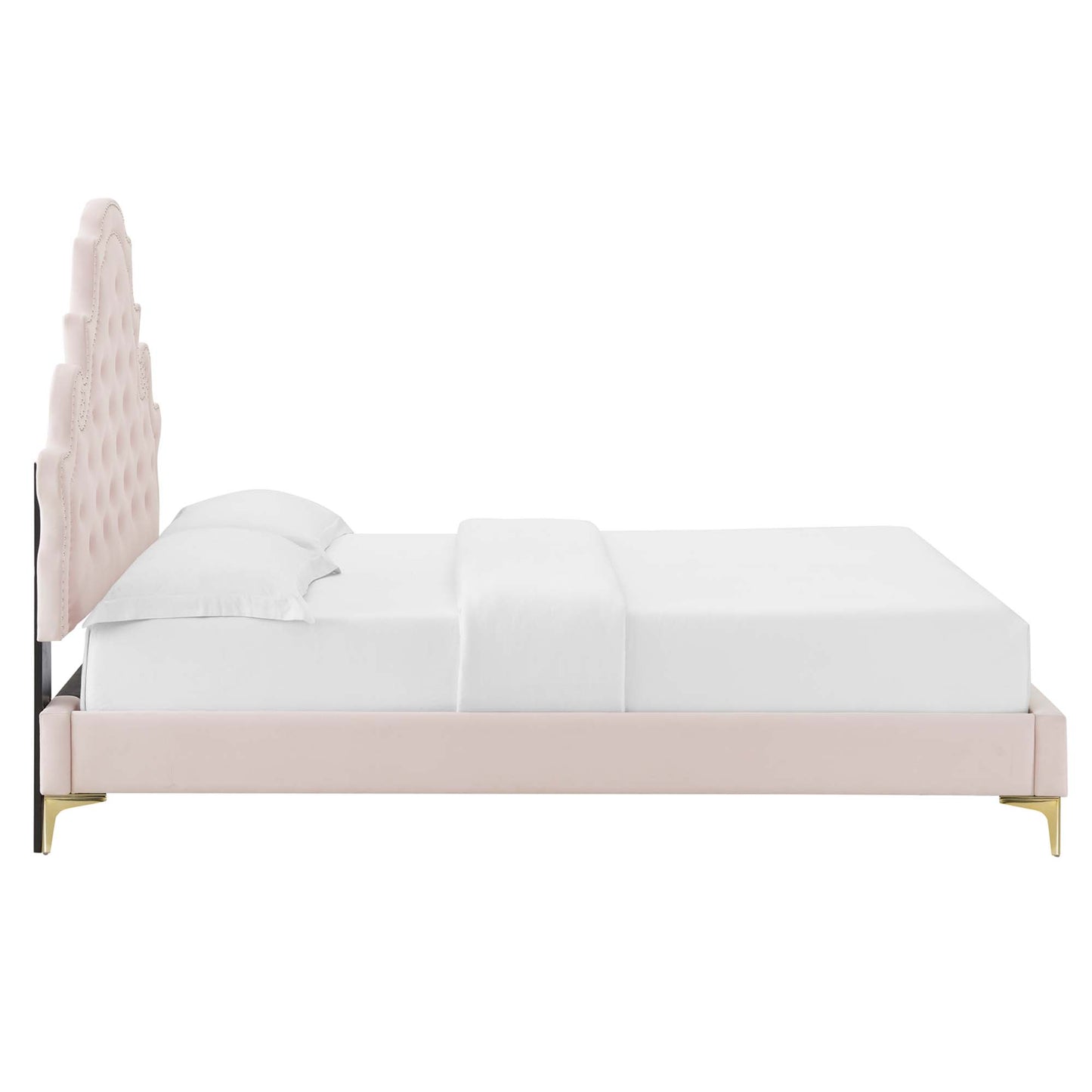 Soft pink velvet bed with a tall tufted arched headboard, gold legs, and white bedding.