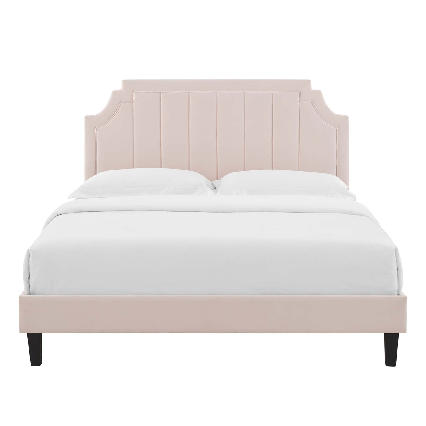 Blush pink upholstered bed with tall paneled headboard and black tapered legs, white bedding.