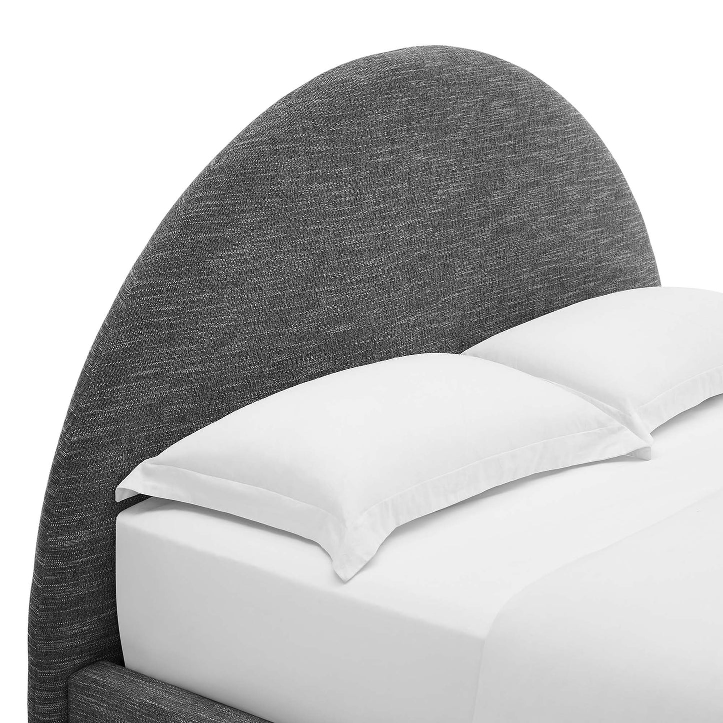 Curved dark grey upholstered headboard with white bed linens and pillows for a modern bedroom setup.