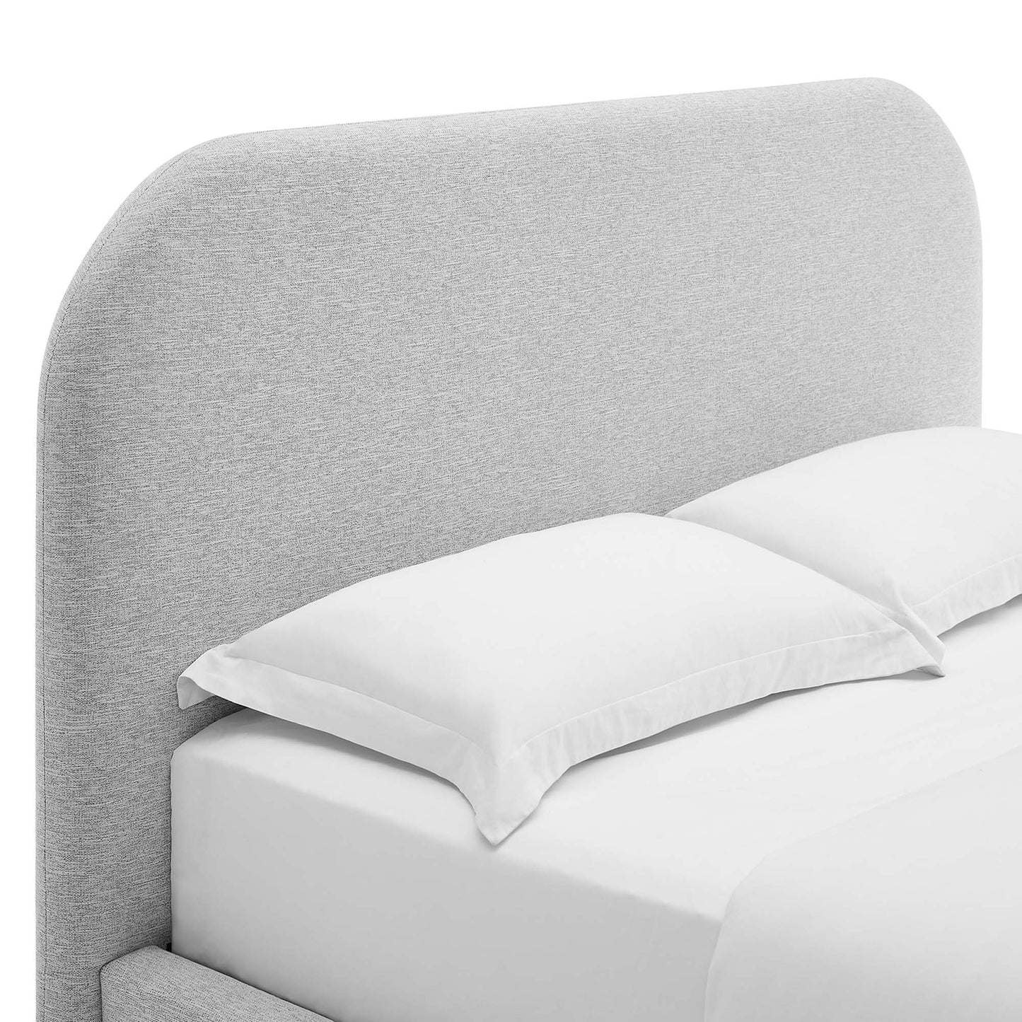 Light gray curved upholstered fabric headboard and matching king bed frame with white sheets and two white pillows.
