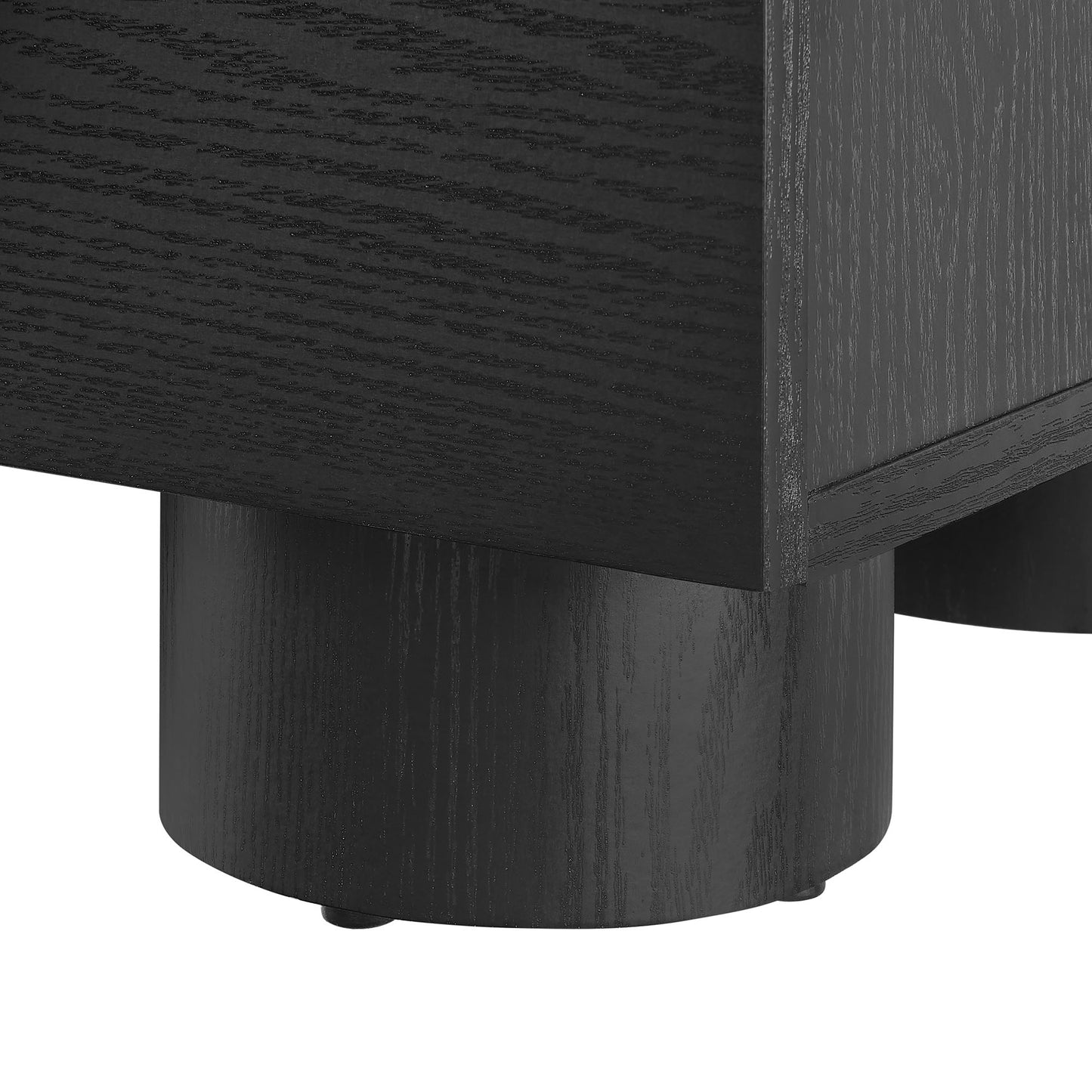 Close-up of a black wood nightstand leg with a cylindrical rounded foot and visible grain.