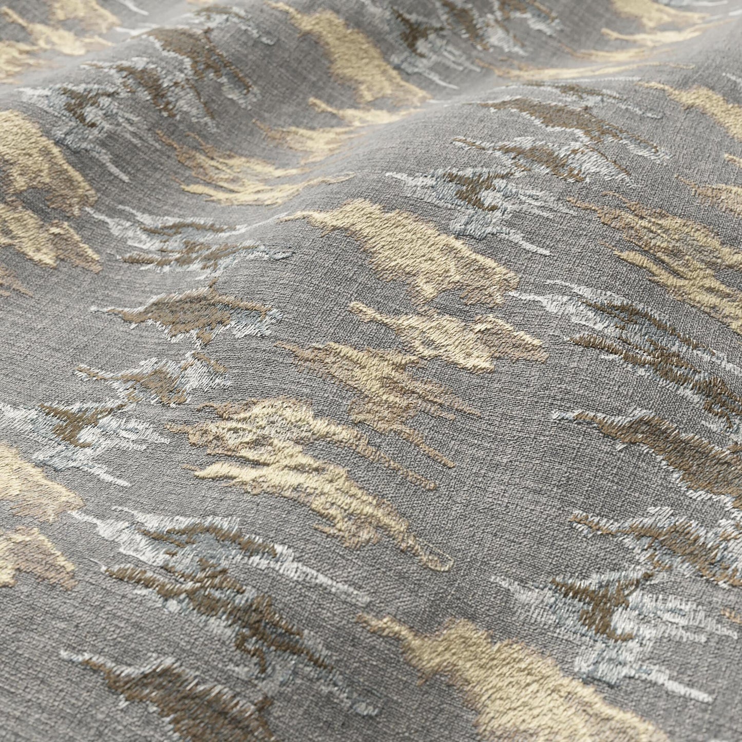 Gray fabric with abstract ikat pattern in beige, ivory and taupe; textured surface.