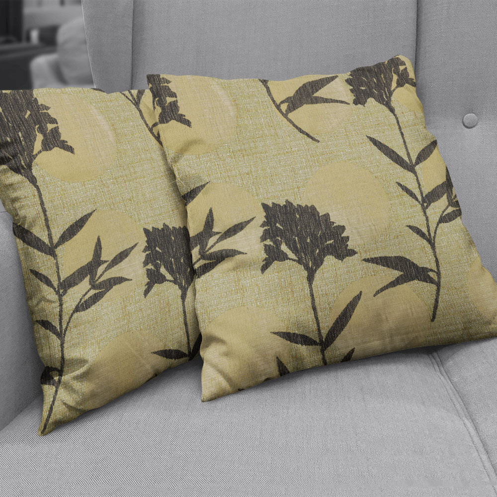 Pistachio geometric-patterned throw pillows on a light gray sofa.