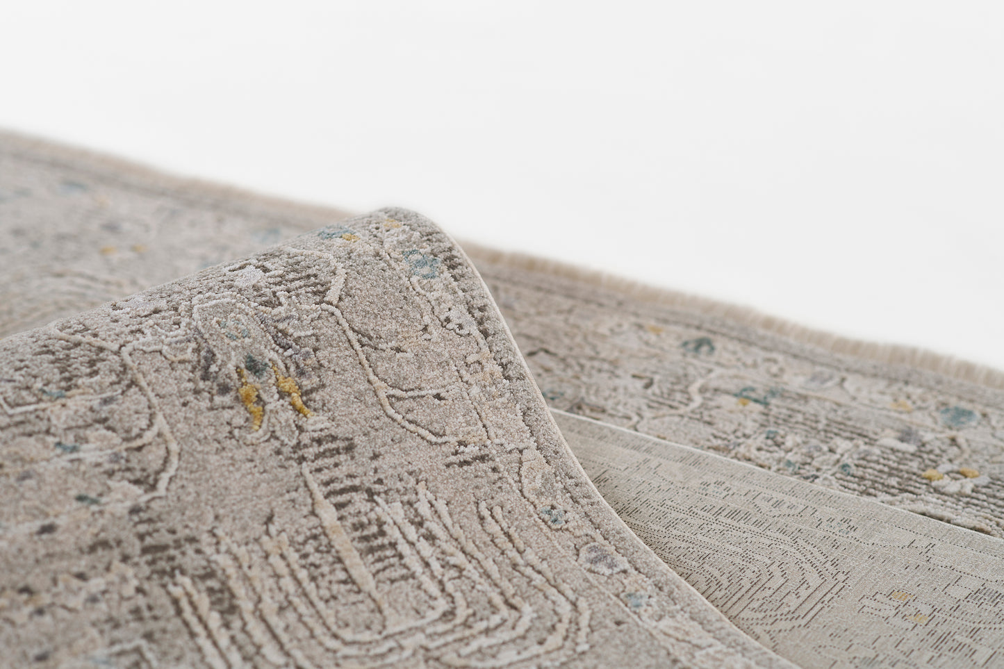 Gray-toned oriental area rug with an intricate medallion pattern, plush pile, subtle blue and yellow accents