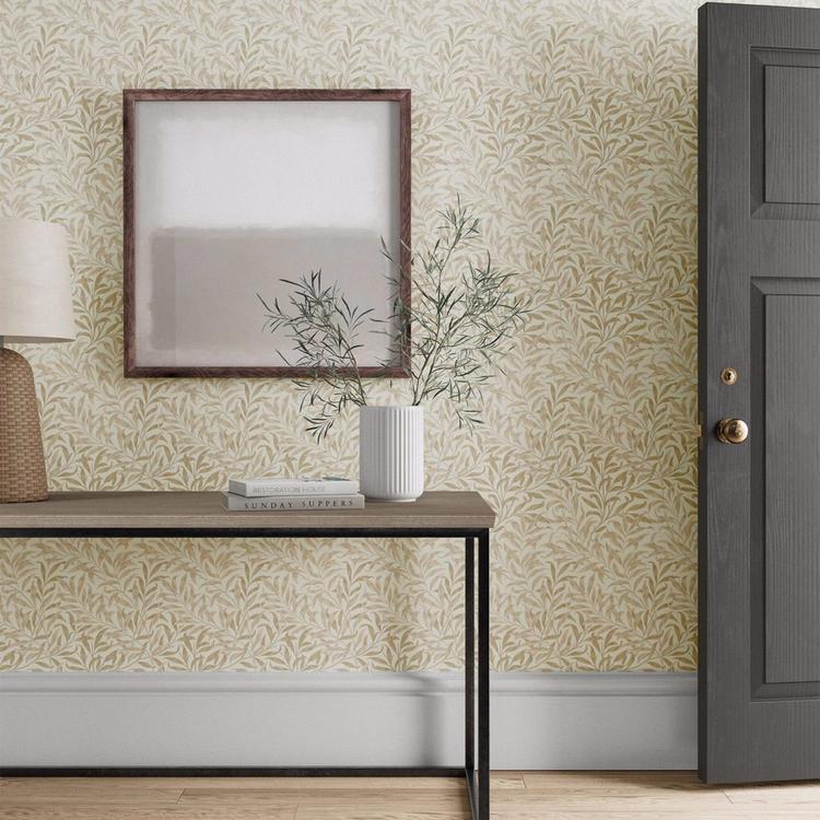 William Morris Willow Boughs Wallpaper in Linen by Morris & Co with flowing willow branches and delicate botanical leaves in soft neutral linen tones. Classic Arts & Crafts wallpaper for elegant living rooms, bedrooms, dining rooms, hallways, and feature walls.