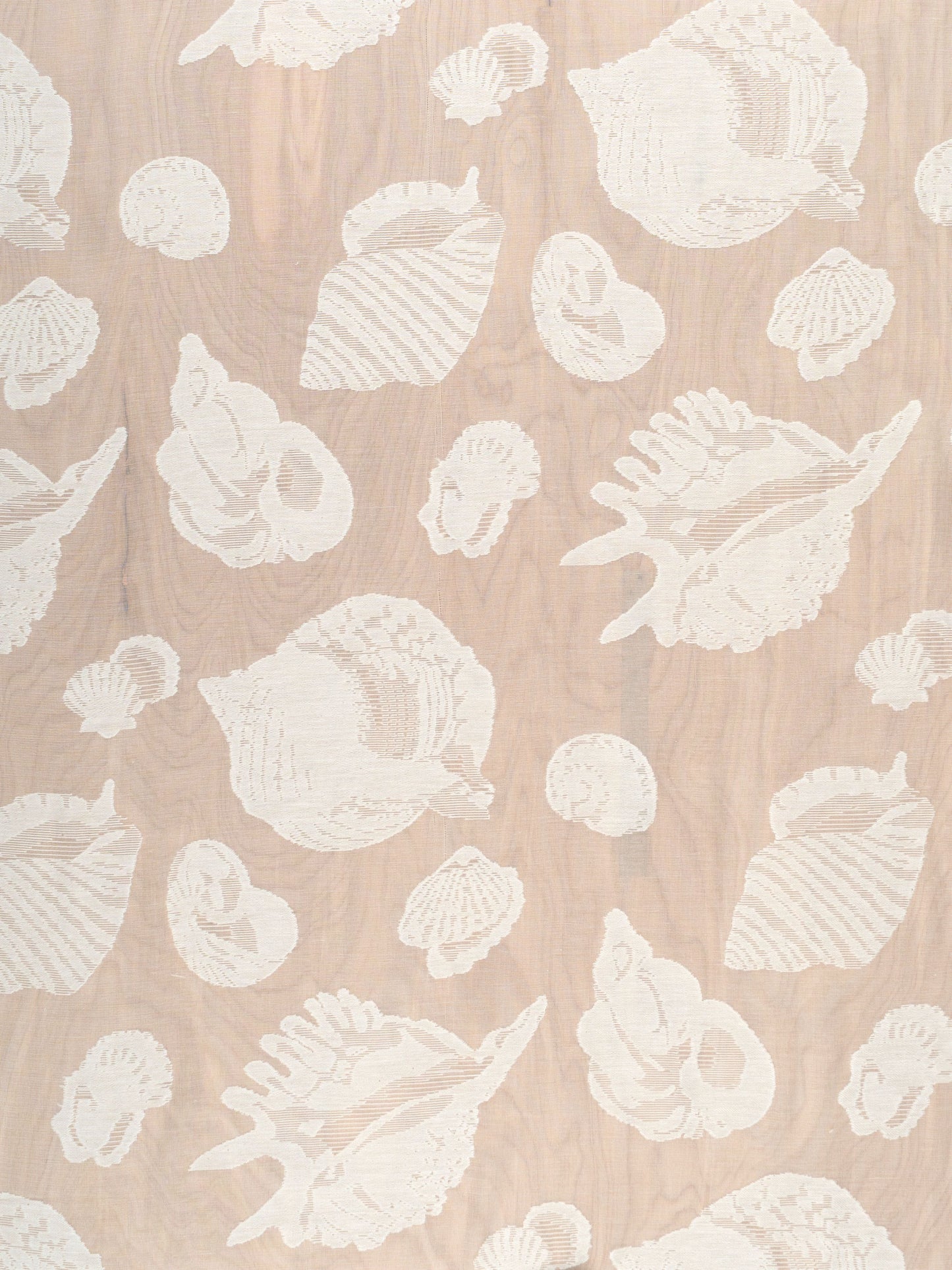 Cream seashell silhouettes on natural sheer fabric with a coastal pattern.