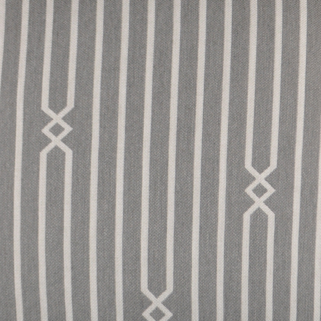 Gray-blue outdoor lumbar pillow with pale vertical stripes and diamond lattice accents; stone stripe pattern.