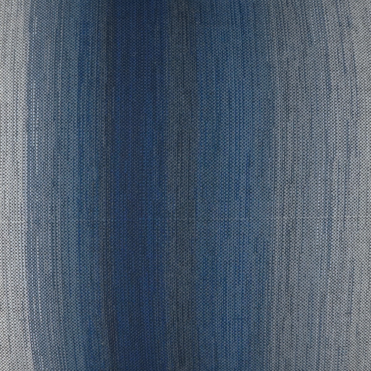 Close-up blue denim fabric with subtle fade, tight twill weave, casual jean-style textile.