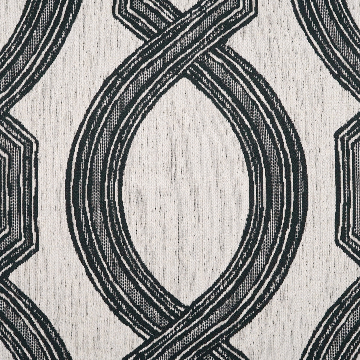 Cream fabric with large black interlocking loop motif; woven texture for upholstery or drapes.