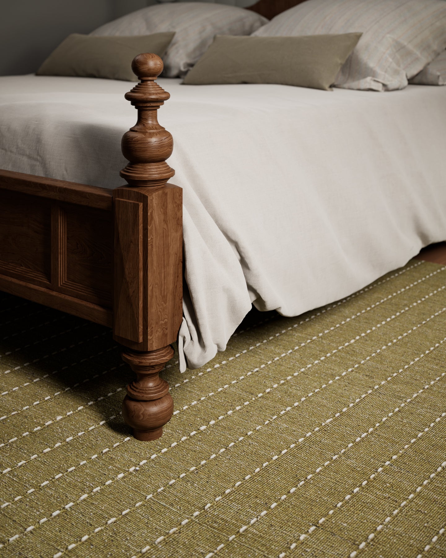 Olive green woven rug with white dashed lines under a carved wooden bed frame.
