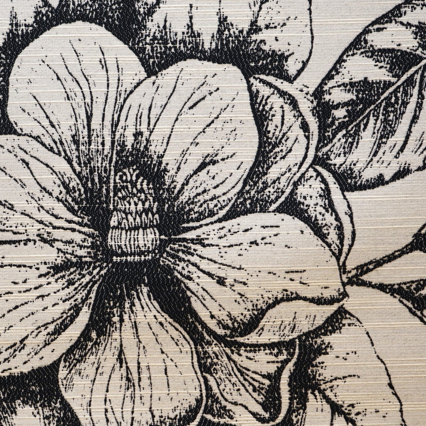 Black-and-white magnolia floral jacquard design on textured linen-style fabric.